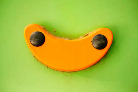 POZNAN, POLAND - Dec 12, 2019: Orange climb handle on a green wall.