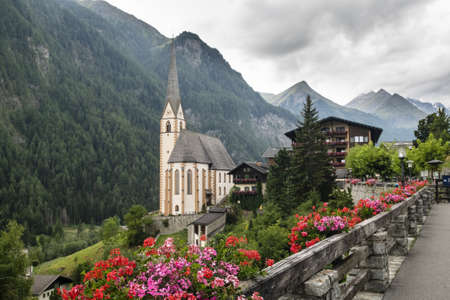A beautiful shot of Saint Vincent Church in Heiligenblut, Austria with high mountains in the backgroundのeditorial素材