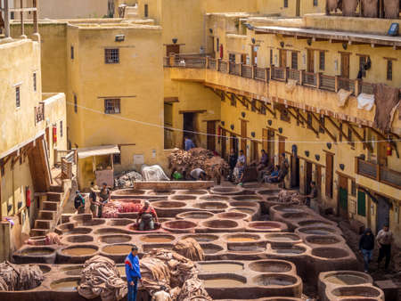 FEZ, MOROCCO - Jun 05, 2018: Workers are dyeing leather at the tannery in Fez, Fes el Bali, Morocco, Africaのeditorial素材
