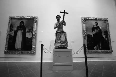 religious statue in a museum in spain , monk with cross