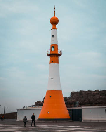 BREMERHAVEN, GERMANY - Nov 01, 2019: The well known lighthouse called onion dome, with teal and orange stripes, next to the zoo "Zoo am Meer" in Bremerhaven, Germany.のeditorial素材