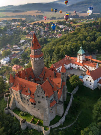 BOUZOV, CZECH REPUBLIC - Aug 12, 2016: Wideshot od hot air balloons with beautiful castle...