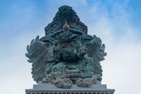 KUTA, INDONESIA - Jan 04, 2020: The Garuda Wisnu statue under a blue sky at Garuda Wisnu Kencana Cultural Theme Park in Baliのeditorial素材