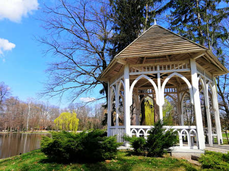 A shot of an arbor next to a pond in Park Norweski in Jelenia GÃ³ra, Polandの写真素材
