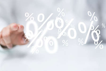 A businessman presenting a virtual projection of percentage icons at a business meetingの写真素材