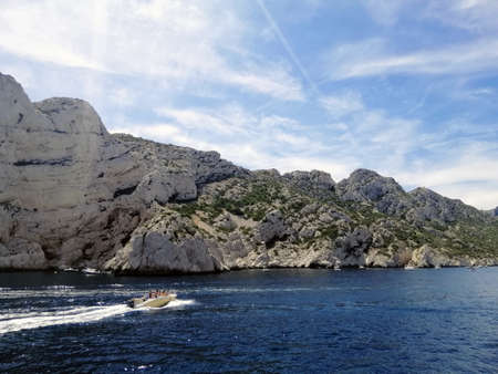 A landscape of The Massif des Calanques surrounded by the sea under the sunlight in Marseilleの写真素材