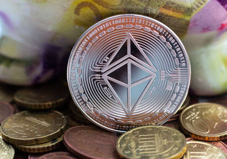 A closeup shot of a large coin surrounded by many others