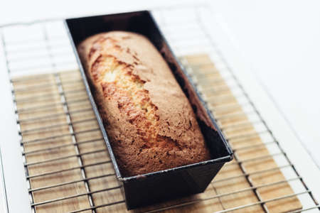A selective focus shot of an organic bread in a baking pan