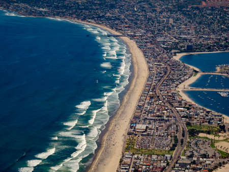 The Pacific Ocean to the left, a strip of beach running up the middle with surf
