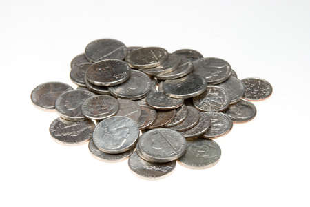 An overhead shot of silver coins in a white surface background
