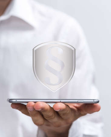 A businessman presenting a virtual projection of a paragraph law signの写真素材