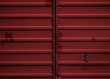 A closeup shot of a metal red gate perfect for using as a background