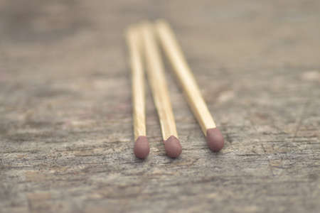 A selective focus closeup shot of three match sticks on a surface