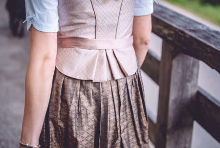 A closeup shot of the back of a woman wearing a skirt and a tieの写真素材