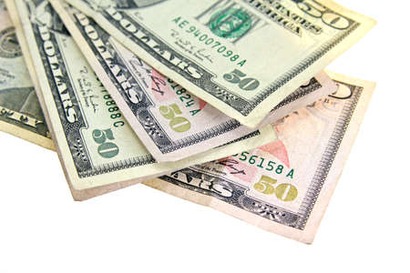 An overhead shot of dollar bills laid in a white surface