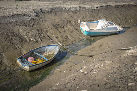 A photo of two boats docked on a beach canal