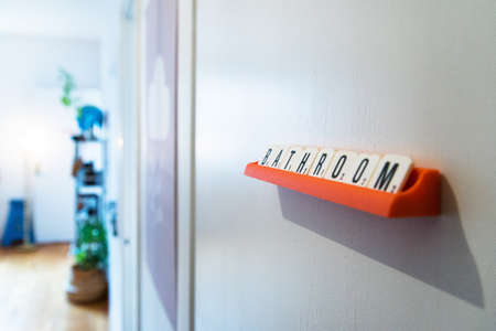 A lot of wooden letters spelling out bathroom hanging on a wallの写真素材
