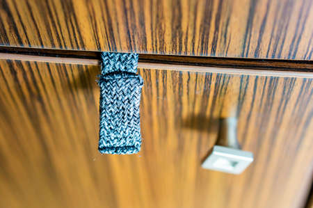 A closeup shot of a cloth sticking out of the cabinet