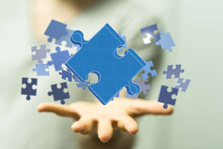A person presenting a virtual projection of puzzles - business solution concept