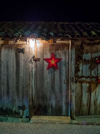 A vertical shot of a wooden house decorated for the Christmasの写真素材
