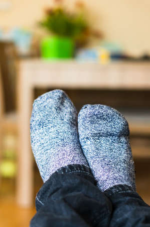 A vertical shot of a person wearing gray socksの写真素材