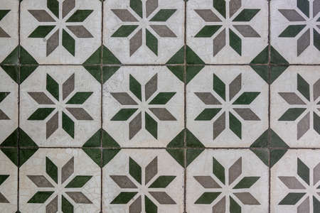 A closeup shot of floor tiles with green and grey patterns