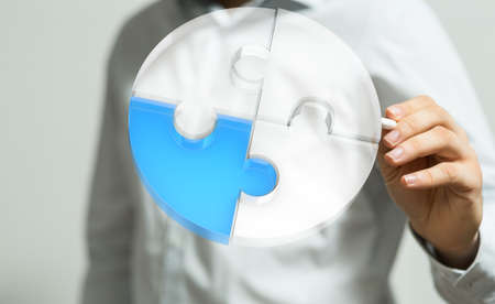 A person presenting a virtual projection of puzzles - business solution concept