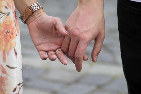 A closeup shot of a couple in love holding handsの写真素材