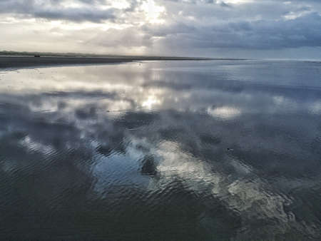 Calm waters of the ocean under a sky full of clouds
