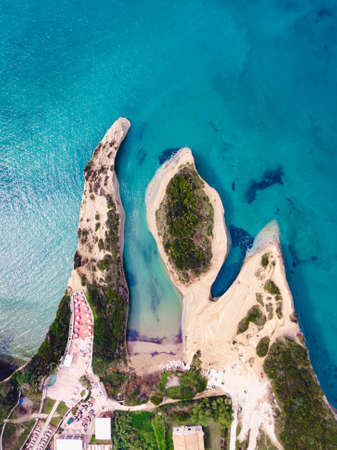 A drone shot of a clear beautiful sea and sandy shoreの写真素材