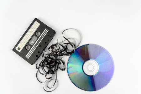 A high angle shot of a cassette and a black tape put in front of a CD diskの写真素材