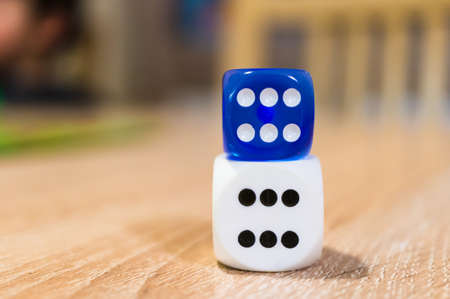 A closeup shot of blue and white dice on top of each other
