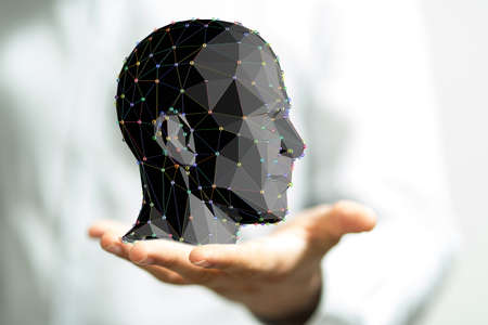 A person touching a virtual projection of a human head - frame of mind conceptの写真素材