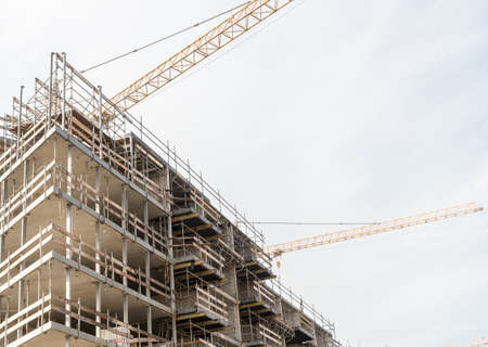 A low angle shot of a building in the middle of the construction