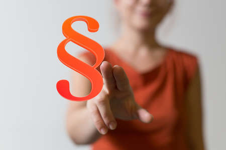 A lawyer working with a virtual projection of a digital paragraph law symbolの写真素材