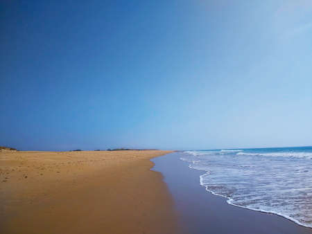 A beautiful shot of the seashore during sunny weather in CÃ¡diz, Spain.