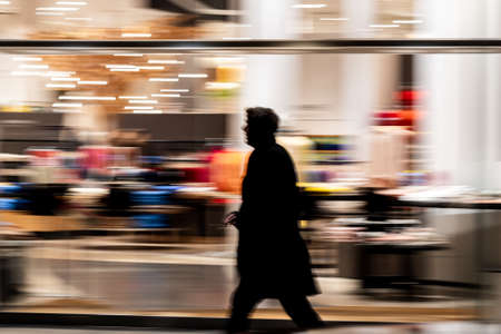 A wide angle shot of a person rushing through  a room full of itemsの写真素材