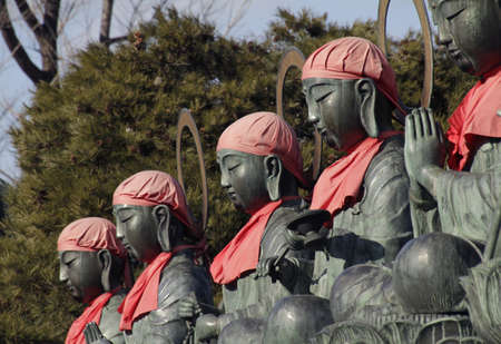 A wide angle shot of statues next to each other wearing pink hats