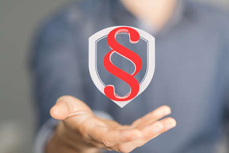 A person showing a virtual projection of a digital paragraph law symbolの写真素材