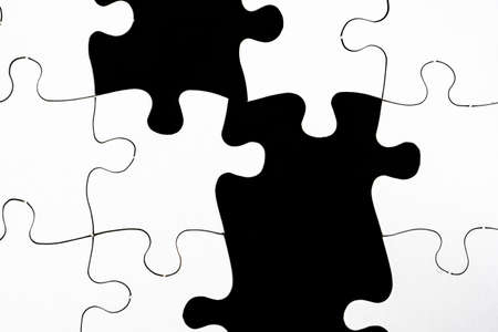 An illustration of black and white pieces of a jigsaw puzzle