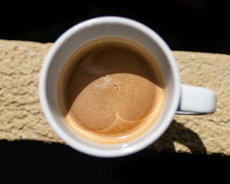 A beautiful shot of a morning coffee in a white cup