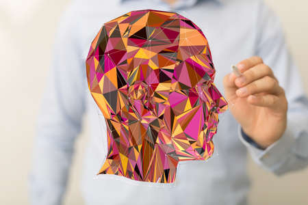 A shot of a person drawing a colorful human head with dots on the edges
