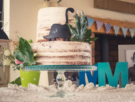A selective focus shot of a vanilla cake covered in chocolate powderの写真素材
