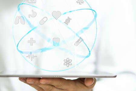 A person working with a digital interface of health insuranceの写真素材