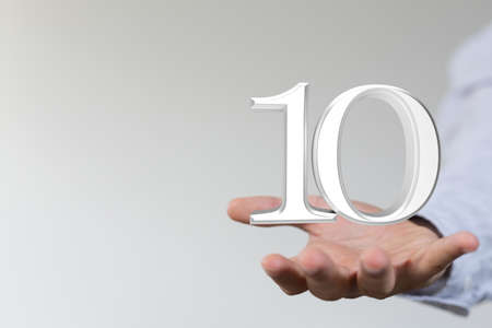 A person presenting a visual projection of digital number ten at a meetingの写真素材