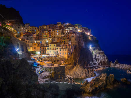 A beautiful view of lights in manarola town of cinque terre italyの写真素材