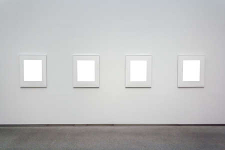 Several square white surfaces attached to a wall in a roomの写真素材