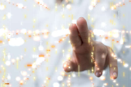 A businessman touching virtual document icons at a business meetingの写真素材