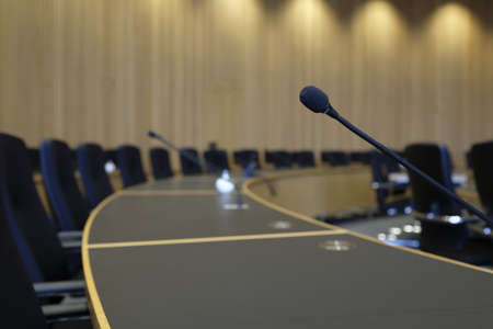 A selective focus shot of a goose neck microphone in conference roomの写真素材