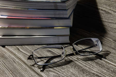 An overhead shot of an eyeglass laid in a gray table